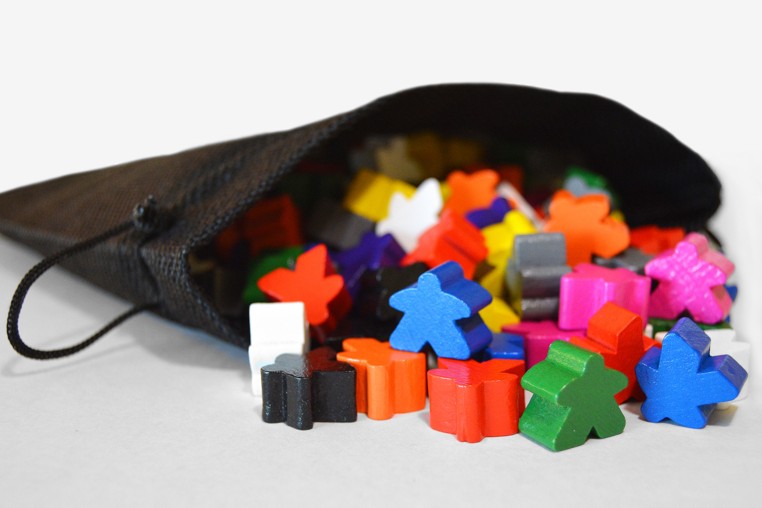 Colorful meeples spilling from the game's Polybag