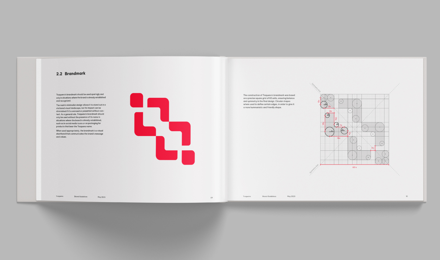 A double-page spread from the Traqueno brand guidelines, showcasing the brandmark and its construction. On the left page, the brandmark is displayed in red. On the right page, a grid-based illustration reveals the meticulous design process behind the brandmark's construction. The grid lines and circles highlight the careful arrangement of shapes.