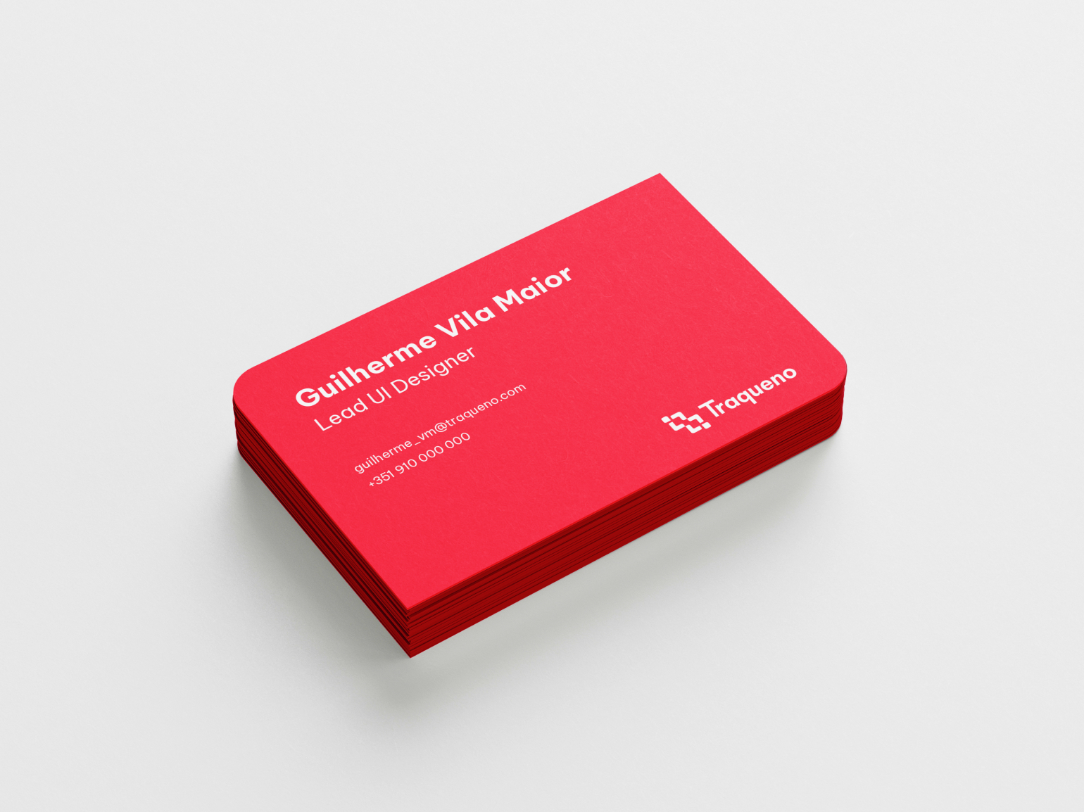 A red stock of business cards on top of each other with rounded corners. The top card reads 'Guilherme Vila Maior, Lead UI Designer' with contact information below.